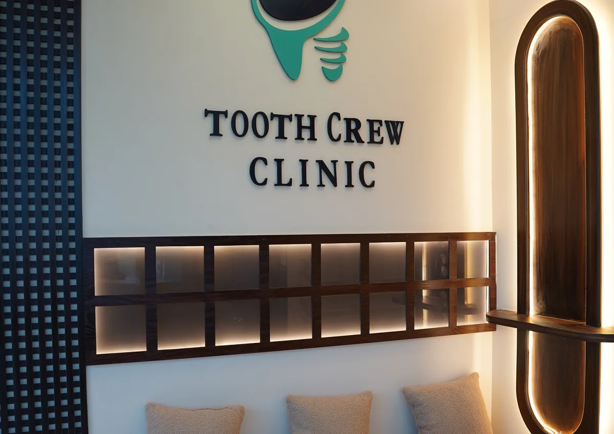 Waiting area with the Tooth Crew Clinic logo wall at the New Blue Area branch